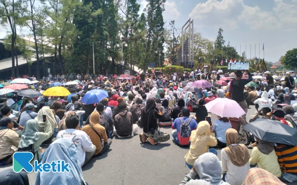 Foto Dreescode peserta unjuk rasa aliansi Jogja memanggil, baju warna cerah dengan payung hitam, yang seringkali menjadi simbol perlawanan damai