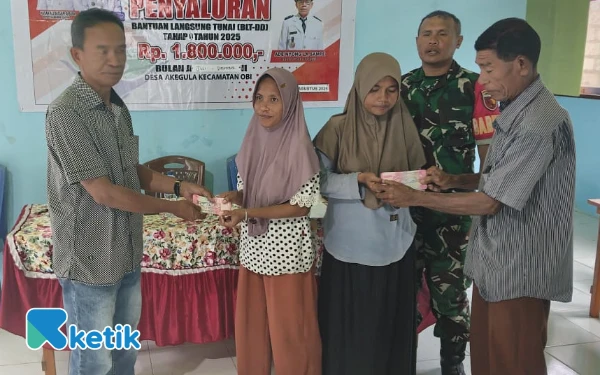 Foto Camat Obi La Ali La Hajaria didampingi Babinsa dan Ketua BPD Akegula menyerahkan BLT ke penerima Manfaat (Foto: Mursal/Ketik)
