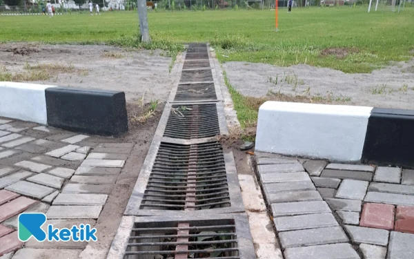 Foto Akibat beban berlebih, struktur besi grill drainase di area Stadion Forlantas tampak bengkok dan ambles, diduga akibat dilalui truk bermuatan material proyek. Kerusakan ini menjadi risiko teknis tambahan di tengah upaya percepatan pembangunan joging track pada akhir tahun.  (Foto: Fajar R/Ketik.com)