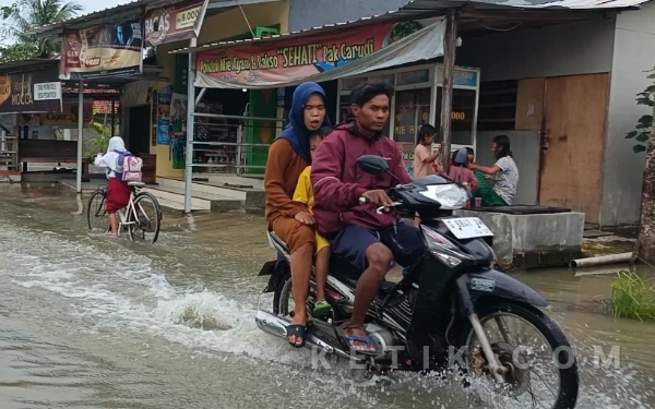 Foto Warga dan Anak Sekolah Menerjang Genangan Air di Dusun Pesarean, Desa Pesantren, Kecamatan Ulujami, Senin, 9 Februari 2026 (Foto: Slamet/Ketik.com)