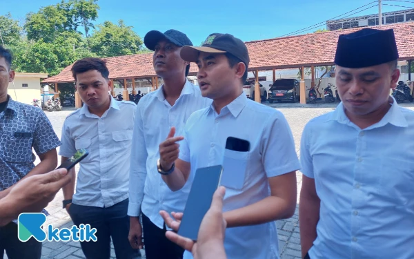 Thumbnail Muafi Asmawi saat menyampaikan kekecewaannya saat diwawancarai rekan-rekan jurnalis soal puluhan nakes yang tidak diusulkan PPPK paruh waktu oleh Dinas Kesehatan Sampang, Senin, 22 September 2025 di halaman kantor DPRD Sampang (Foto: Mat Jusi/Ketik).