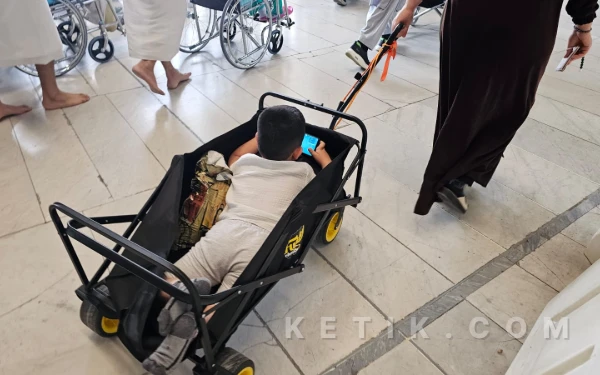 Foto Inilah potret kreativitas orang tua dalam memastikan sang buah hati tetap nyaman beribadah di tengah hiruk-pikuk kota Makkah. (Foto: Muhsin Budiono/Ketik.com)