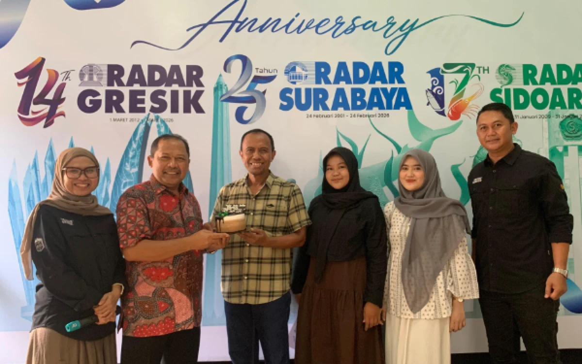 Foto Direktur Bisnis Ketik.com Sumarno (empat dari kanan) menyerahkan kue kepada Direktur Radar Surabaya Lilik Widyantoro. (Foto: Andy Satria/Radar Surabaya)