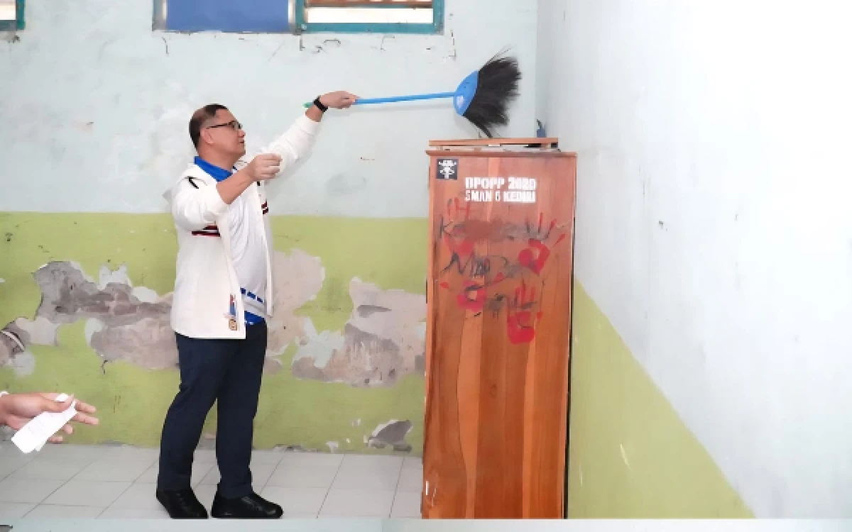 Foto Kadindik Jatim Aries Agung Paewai mmbersihkan bagian atas lemari kelas di SMAN 6 Kota Kediri di sela kunjungannya pada Rabu, 29 April 2026. (Foto: Humas Dindik Jatim)