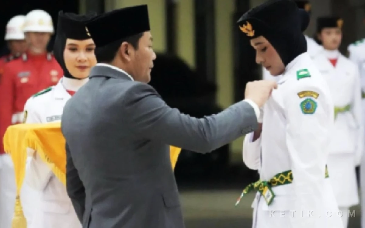 Foto Bupati Subandi menyematkan secara simbolis tanda pengukuhan anggota Paskibraka Kabupaten Sidoarjo. (Foto: Dokumen)