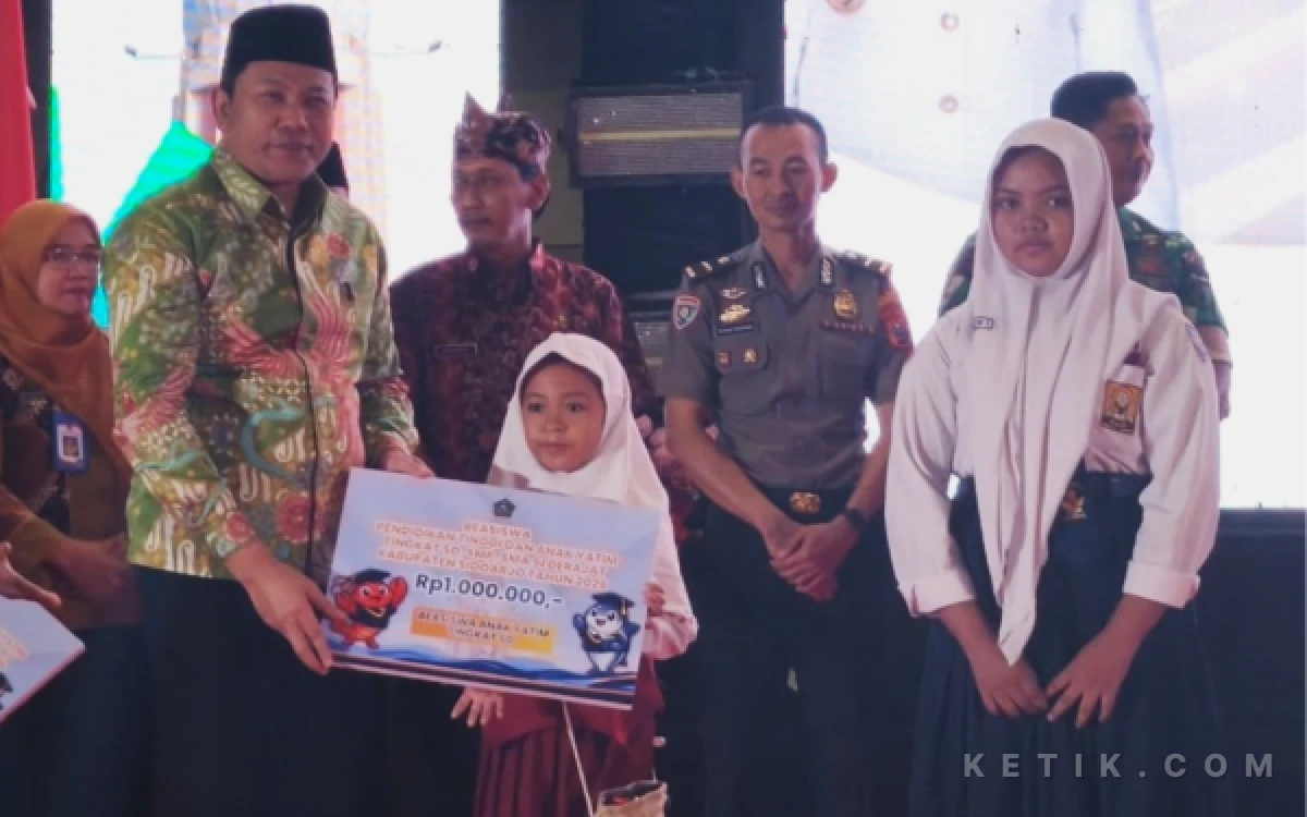 Foto Bupati Subandi menyerahkan beasiswa anak yatim untuk murid SD dan SMP di Kabupaten Sidoarjo. (Foto: Fathur Roziq/Ketik.com)